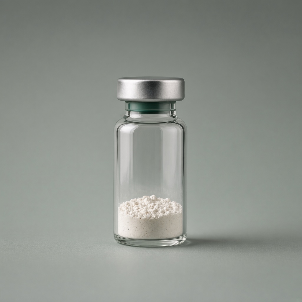 Clear glass research vial with a silver seal and a green neck band, white powder, on a sage surface.